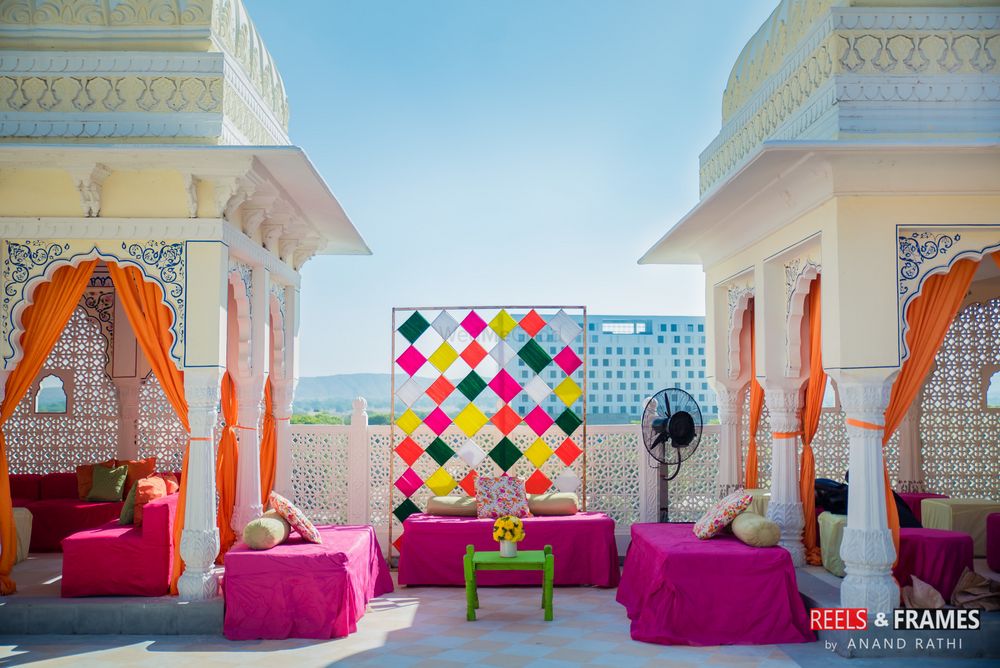 Photo of Bridal mehendi seat with colourful backdrop