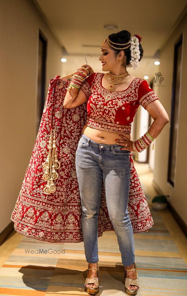 Photo of Cute bride in jeans and red lehenga