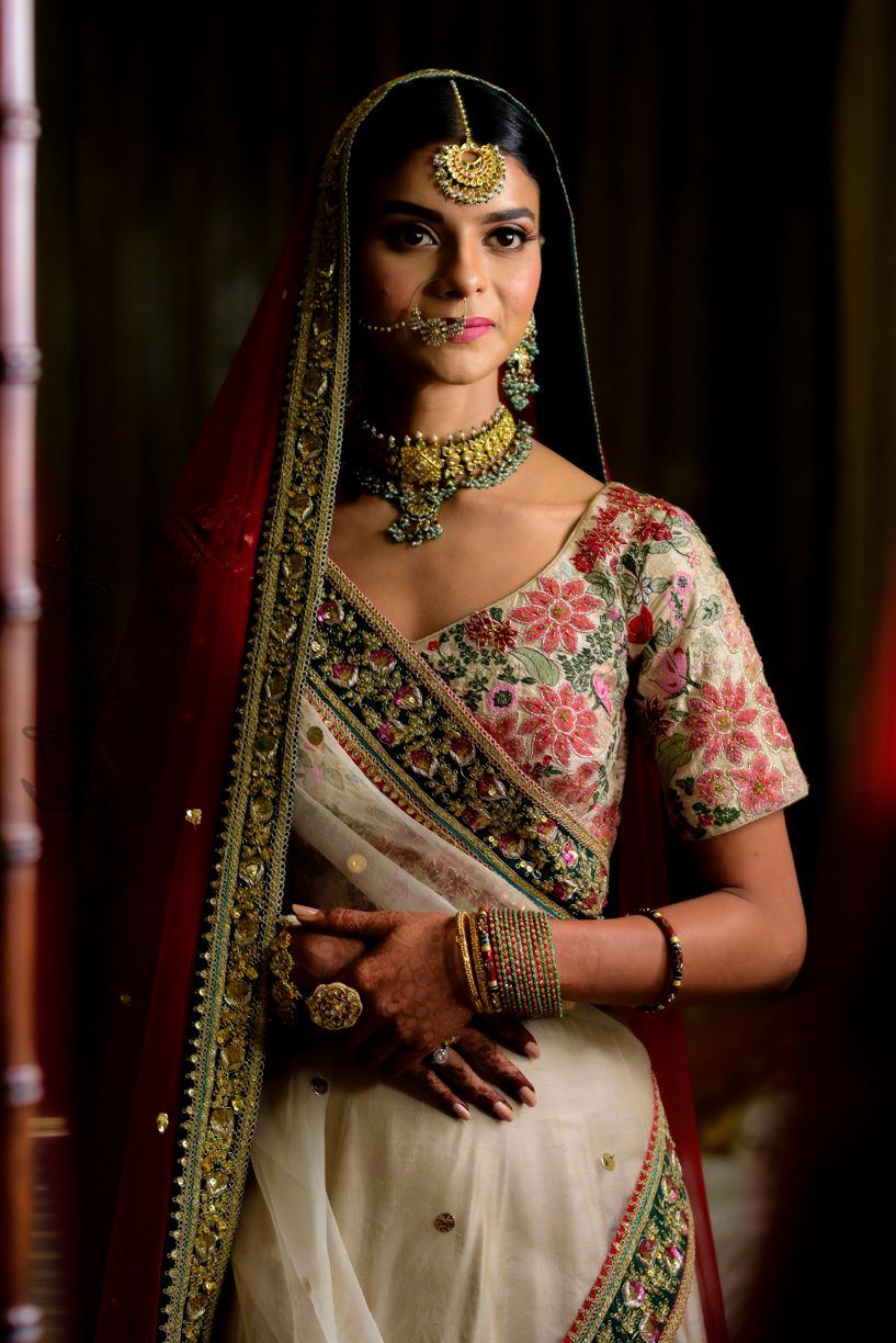 Photo of Indian bride wearing floral lehenga with minimal jewellery for wedding