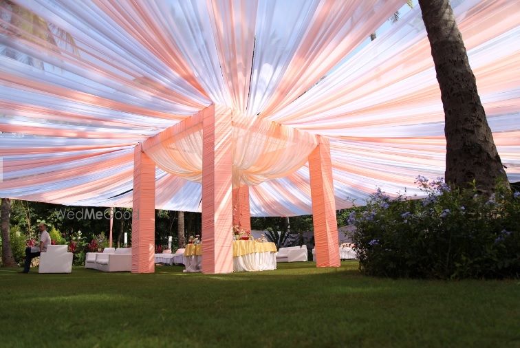 Photo of Pastel peach mandap with fabric tent