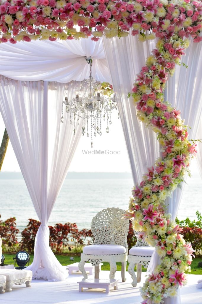 Photo of White and Pink Floral Decor with Chandeliers