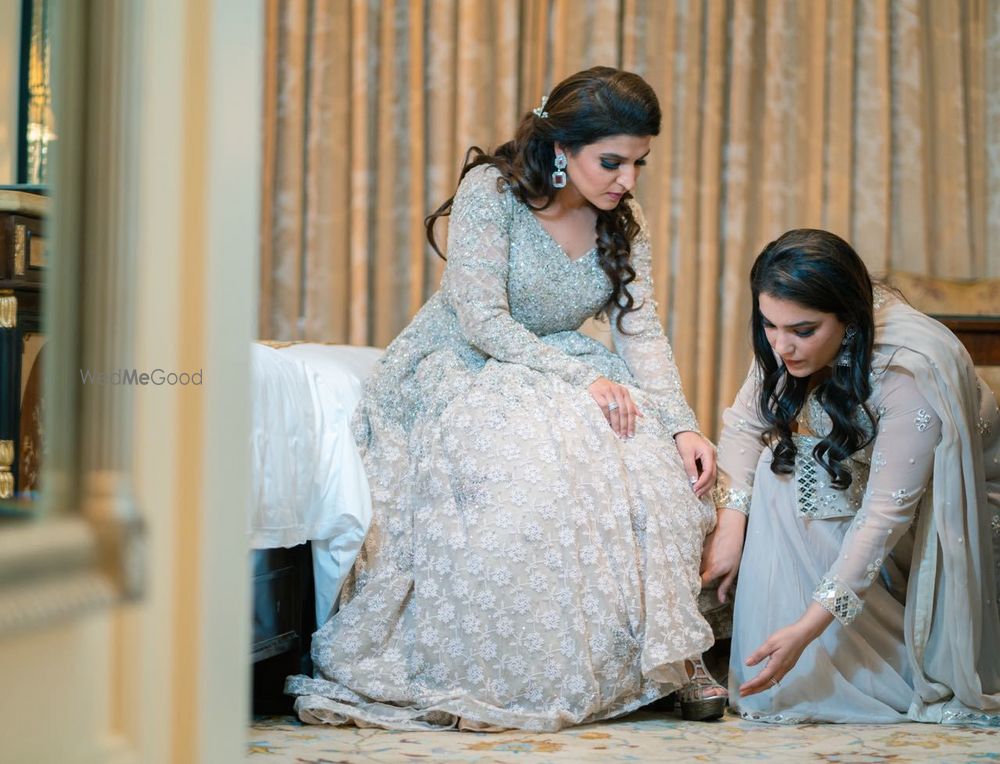 Photo of Sister of the bride helping her to get ready for cocktail