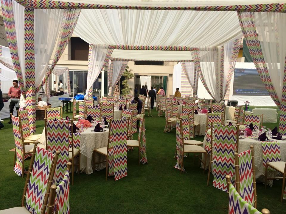 Photo of colorful stripes chairs with white theme mehendi decor