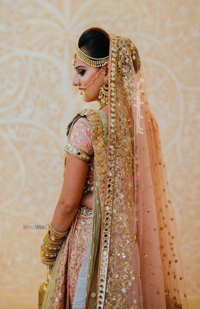 Photo of Wedding day bridal portrait in peach lehenga