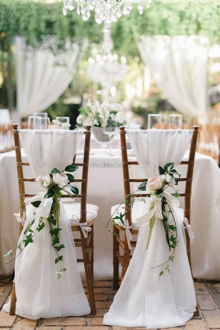 Photo of Simple yet stunning white floral chair decor