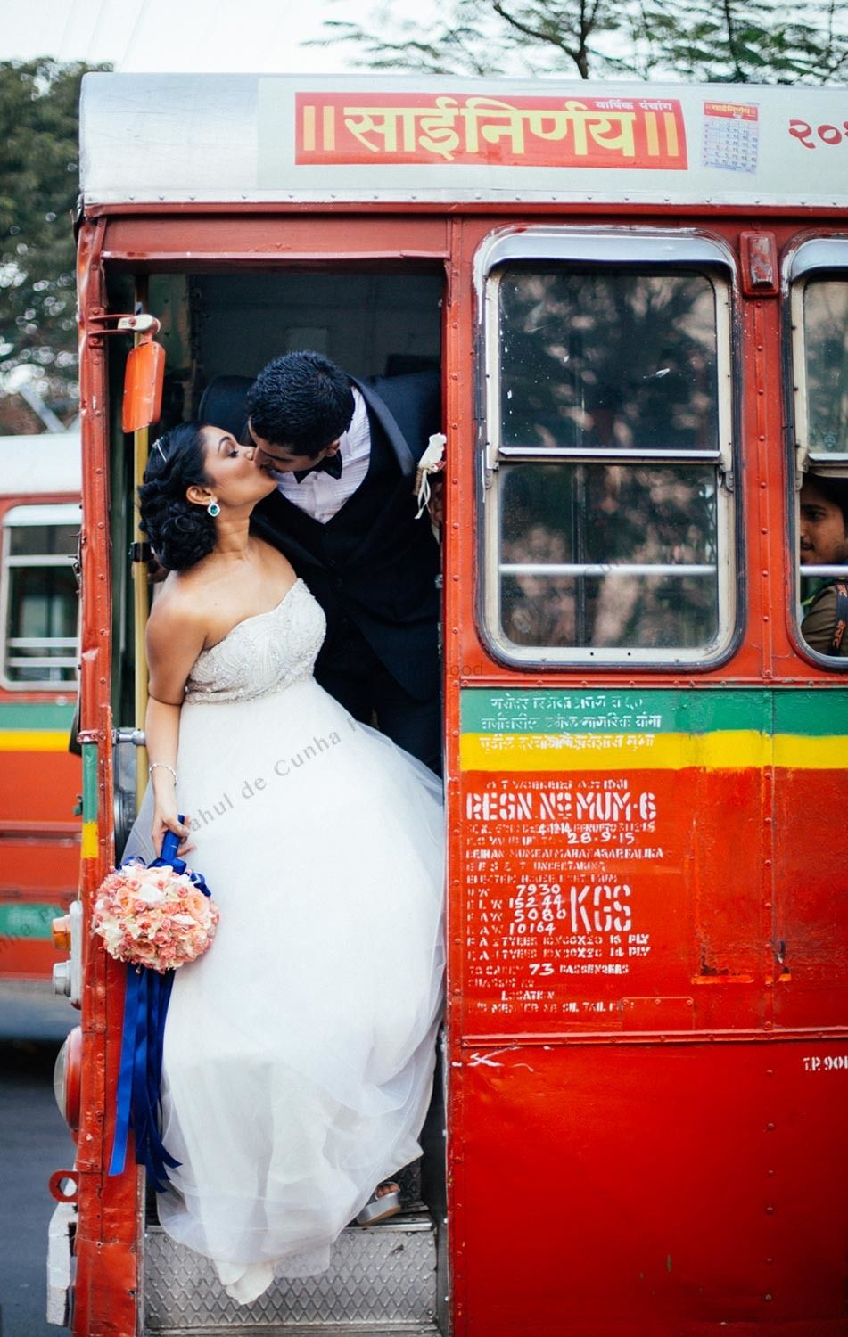 Photo of Couple kissing in best bus post wedding shot