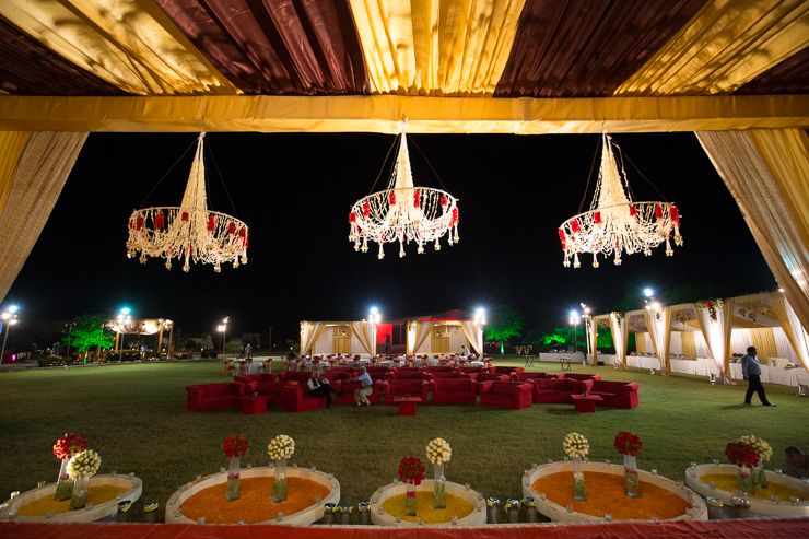 Photo of Marsala and Gold Tent with Floral Chandeliers