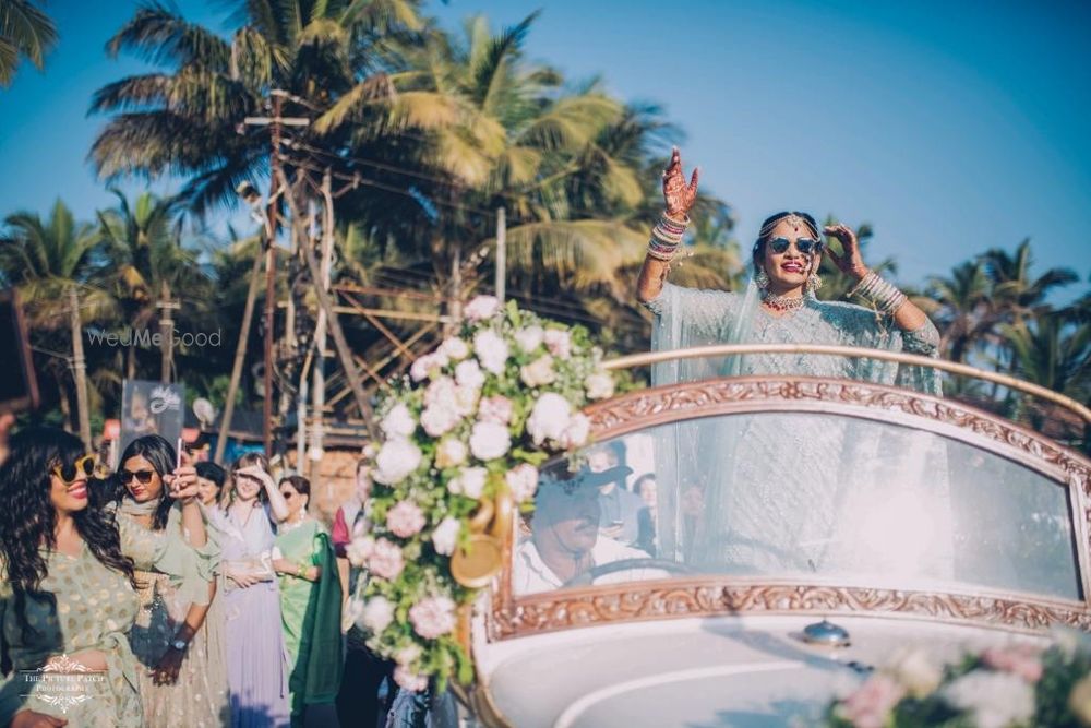 Photo of Bridal entry in vintage car with open top