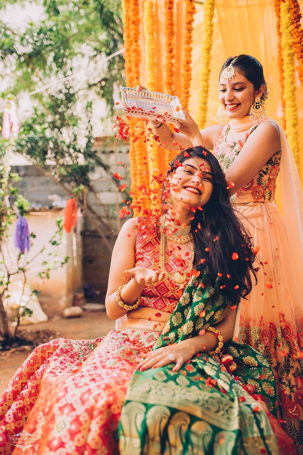 Photo of A bride caught in a candid moment with her sister