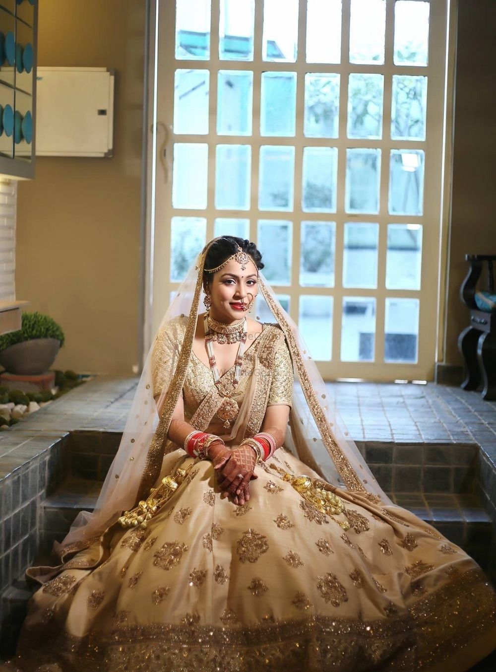 Photo of Single toned gold bridal lehenga with double dupatta drape