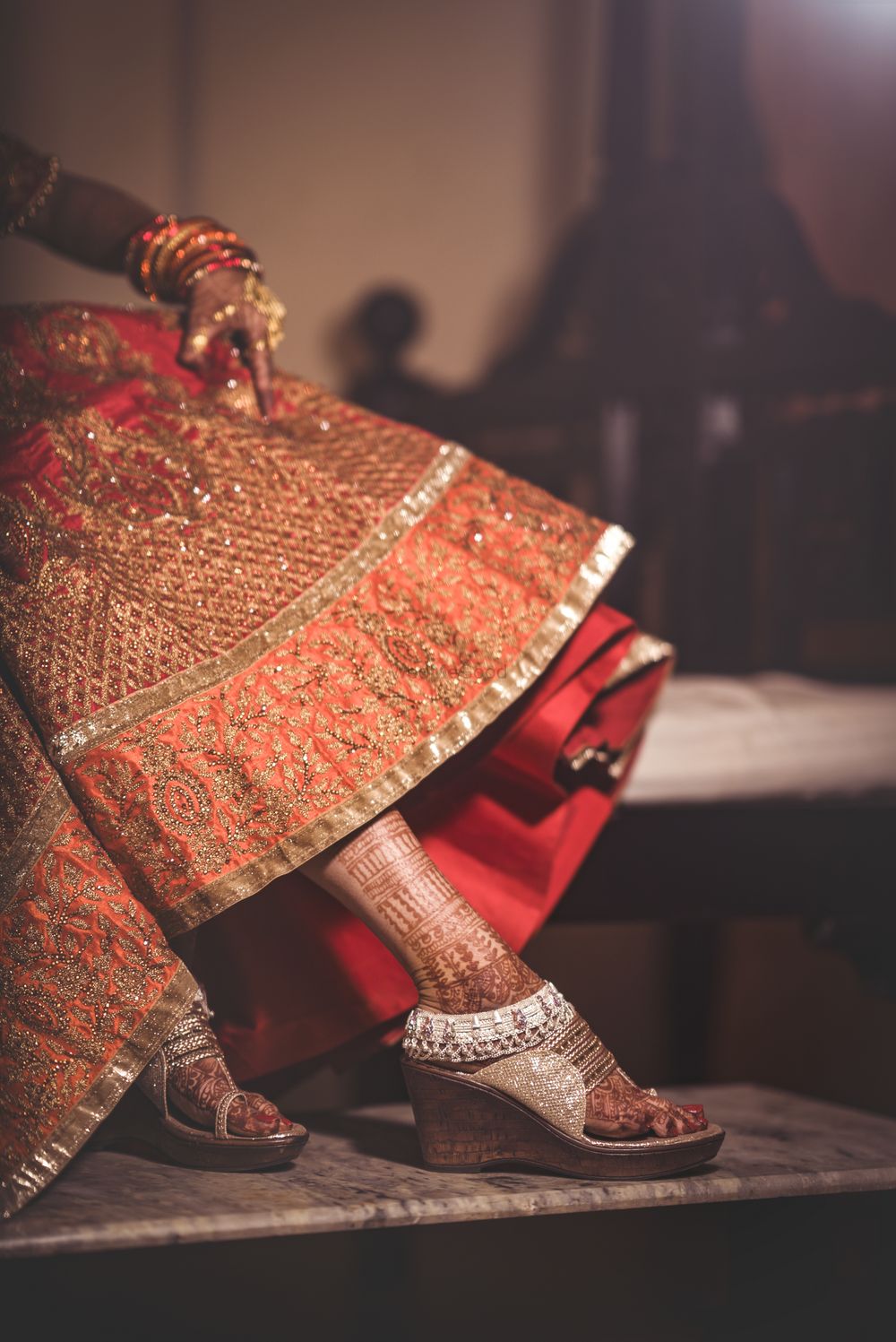 Photo of Unique silver bridal pajeb with orange lehenga