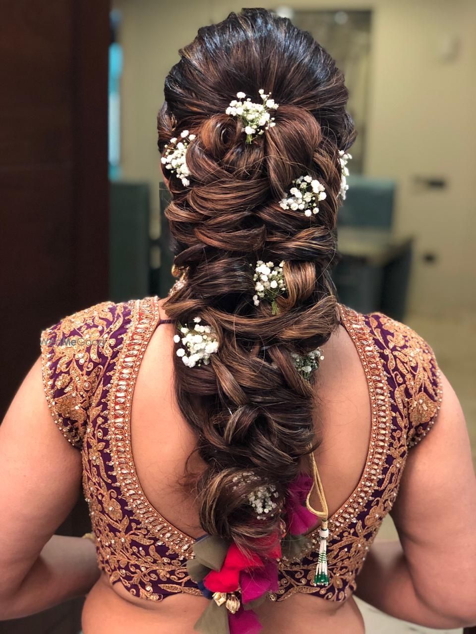 Photo of braided mehendi hairdo idea with babys breath