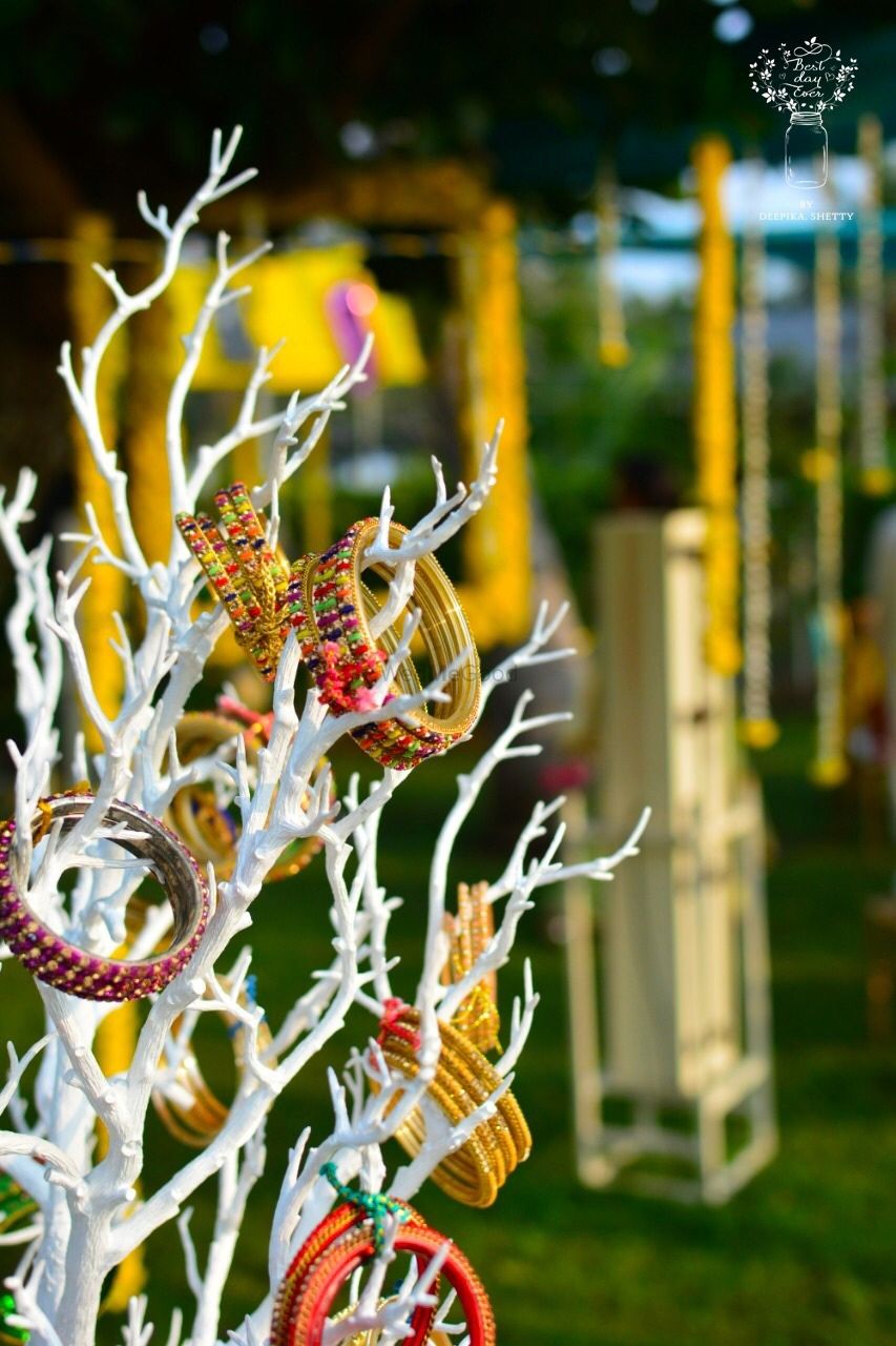 Photo of Bangles on painted branches for mehndi decor