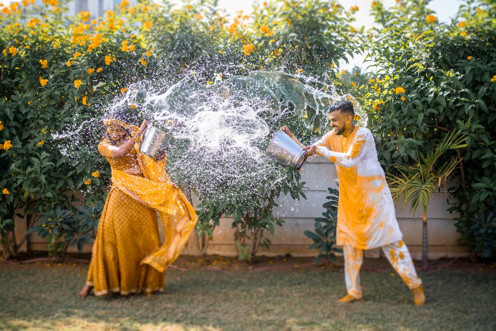 Photo of a fun moment between the bride and groom during haldi