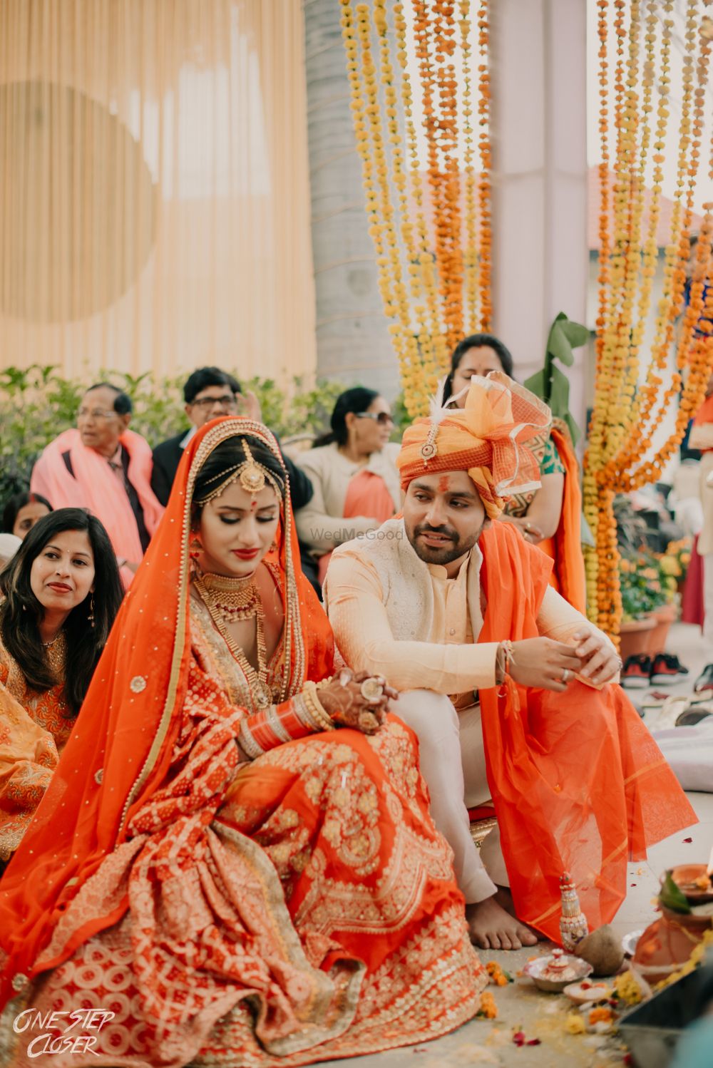 Photo of matching bride and groom in orange on their wedding