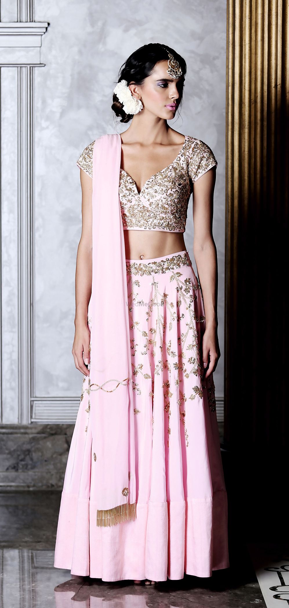 Photo of Pink and gold lehenga with deep cut blouse