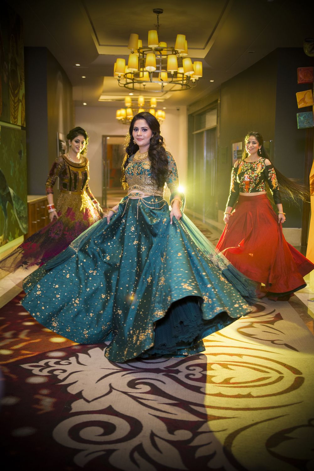 Photo of Bride and bridesmaids dancing on sangeet