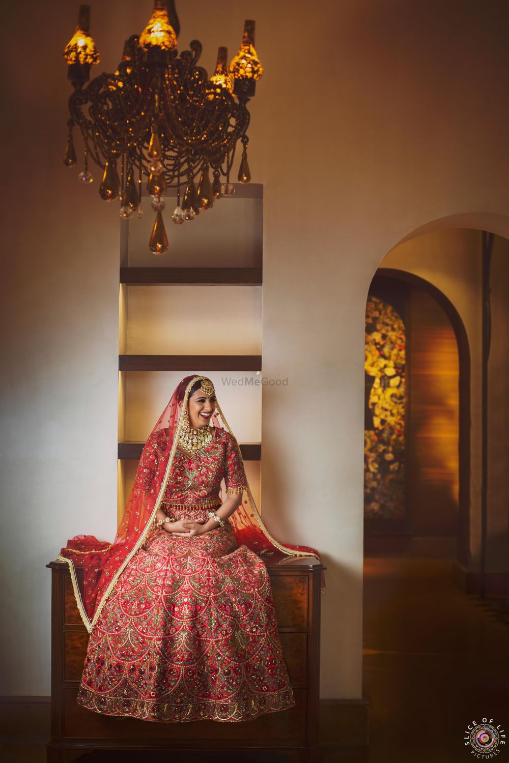 Photo of happy bride in red floral embroidery lehenga