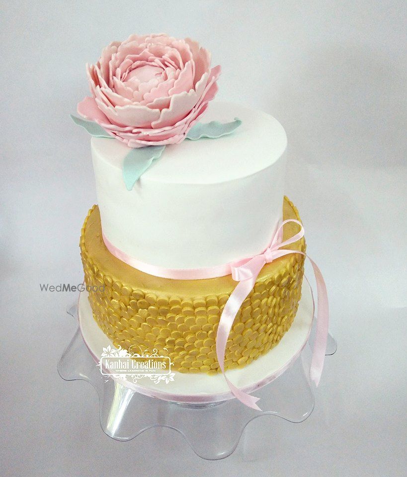 Photo of Elegant two tier wedding cake in white and gold