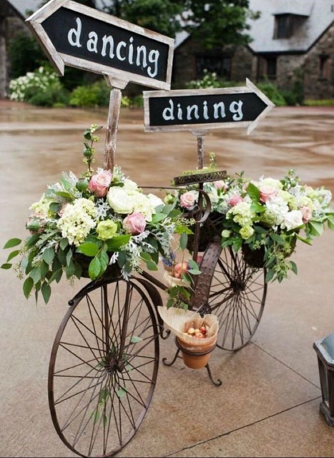 Photo of Cycle with floral decor and signboards.