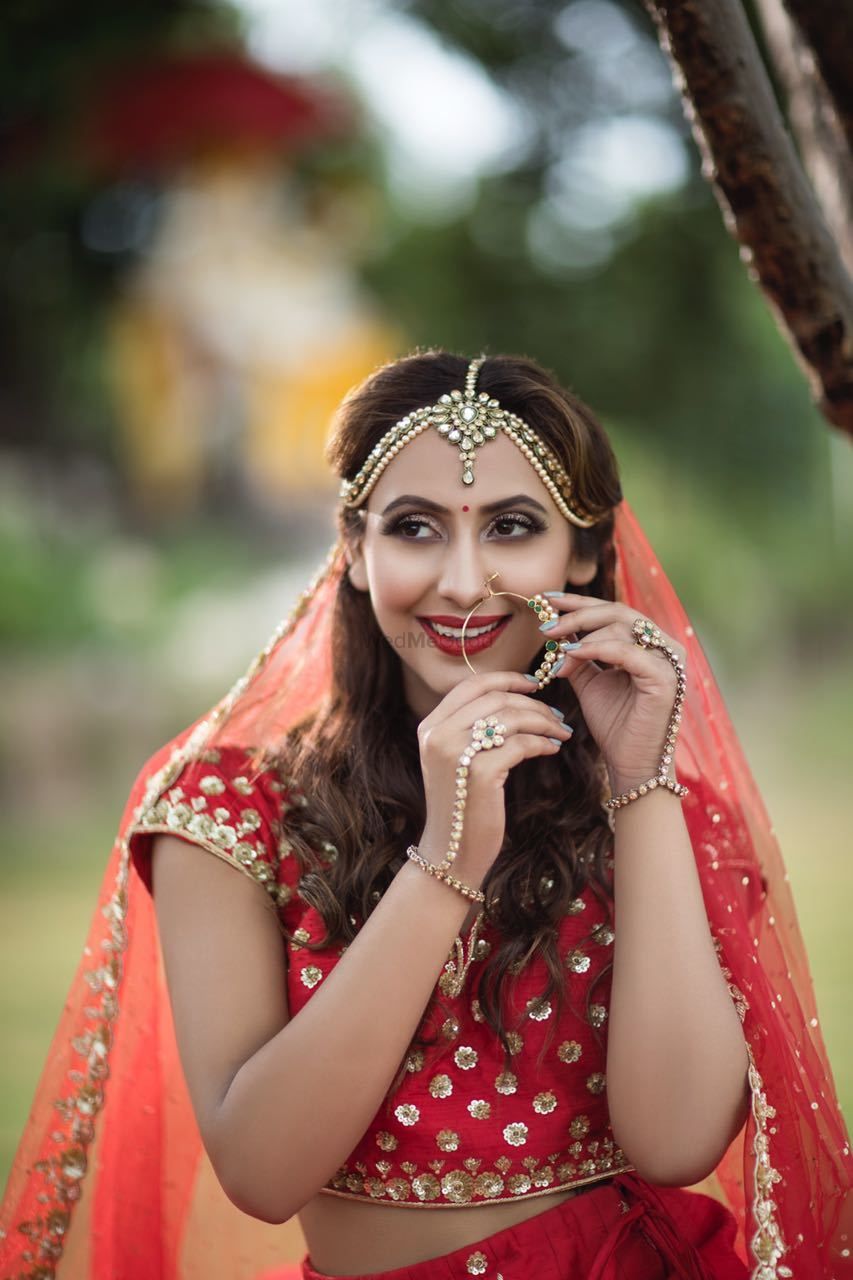 Photo of Modern bridal with open hair and jewellery in red lehenga