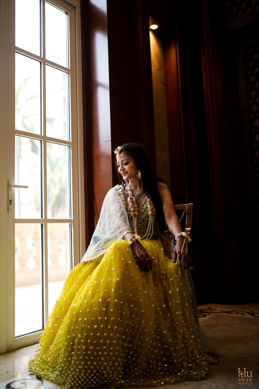 Photo of mehendi bridal look with yellow lehenga and floral jewellery