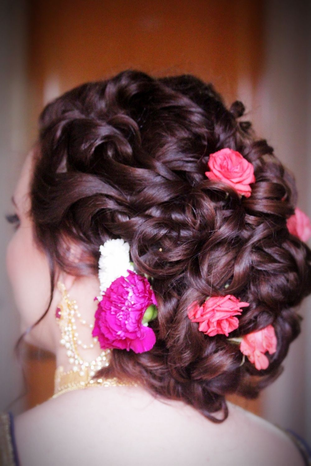 Photo of Bridal bun with pink carnations