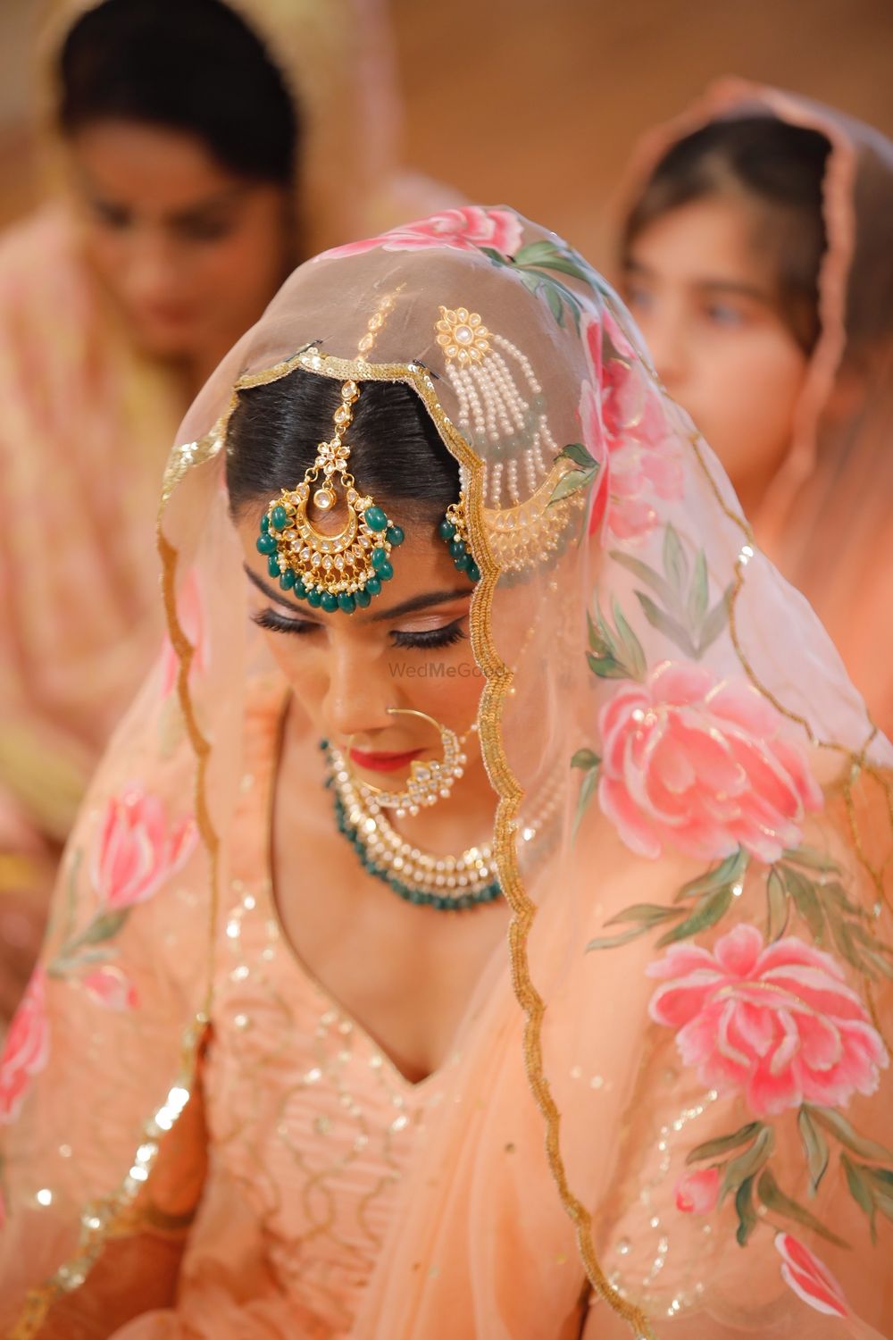 Photo of Bride in peach lehenga and printed dupatta