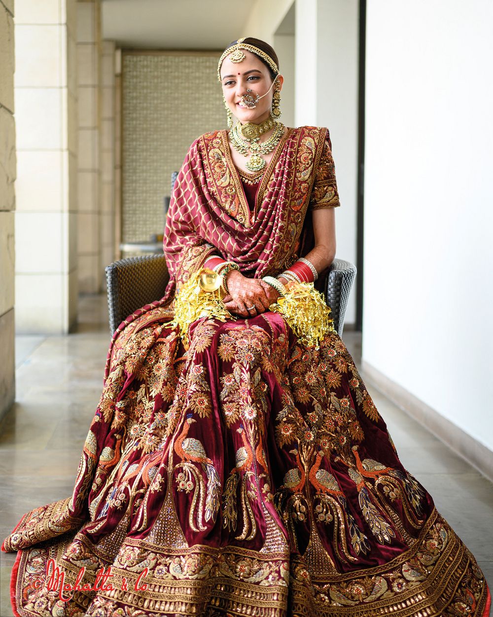 Photo of Bride dressed in a regal lehenga with peacock motifs.