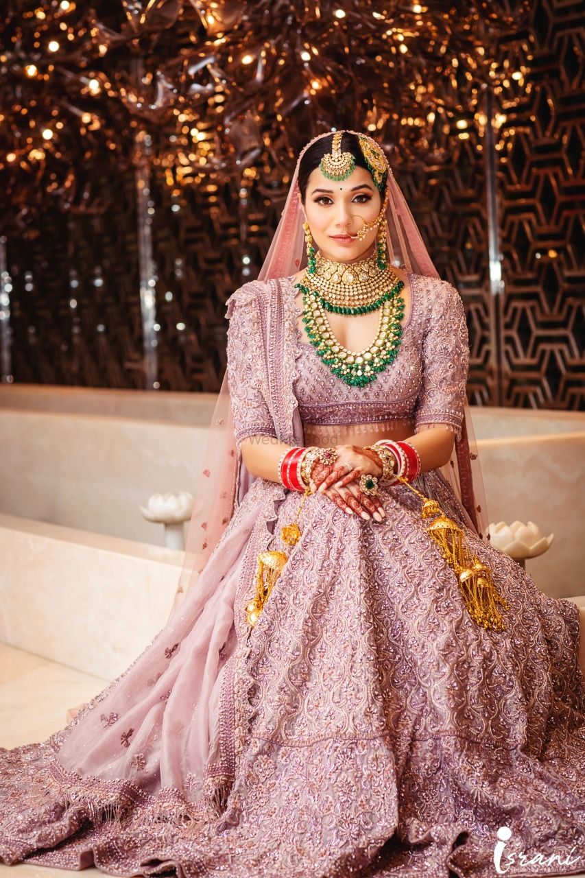 Photo of Bride in gorgeous pastel lehenga and heavy jewellery