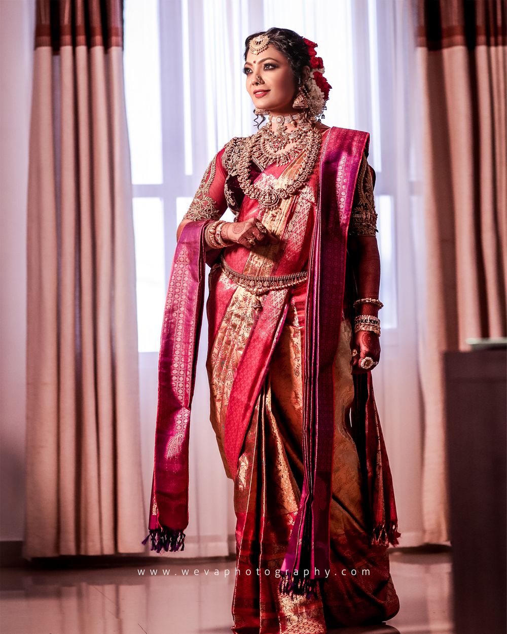 Photo of A south indian bride in red kanjeevaram and temple jewellery