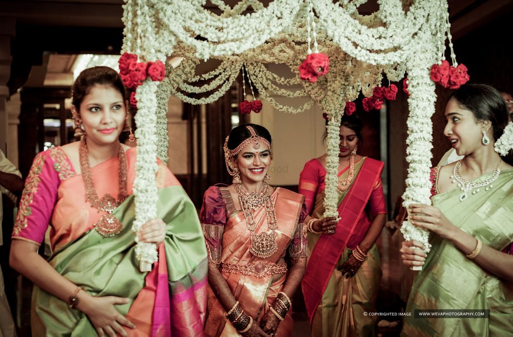 Photo of Pretty south Indian bride entering with her bridesmaids
