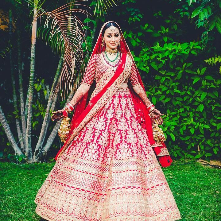 Photo of Red and gold bridal lehenga with floral motifs