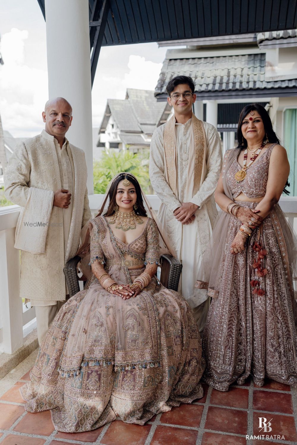 Photo of Classic family portrait of the bride and her family, all in pastels on the wedding day