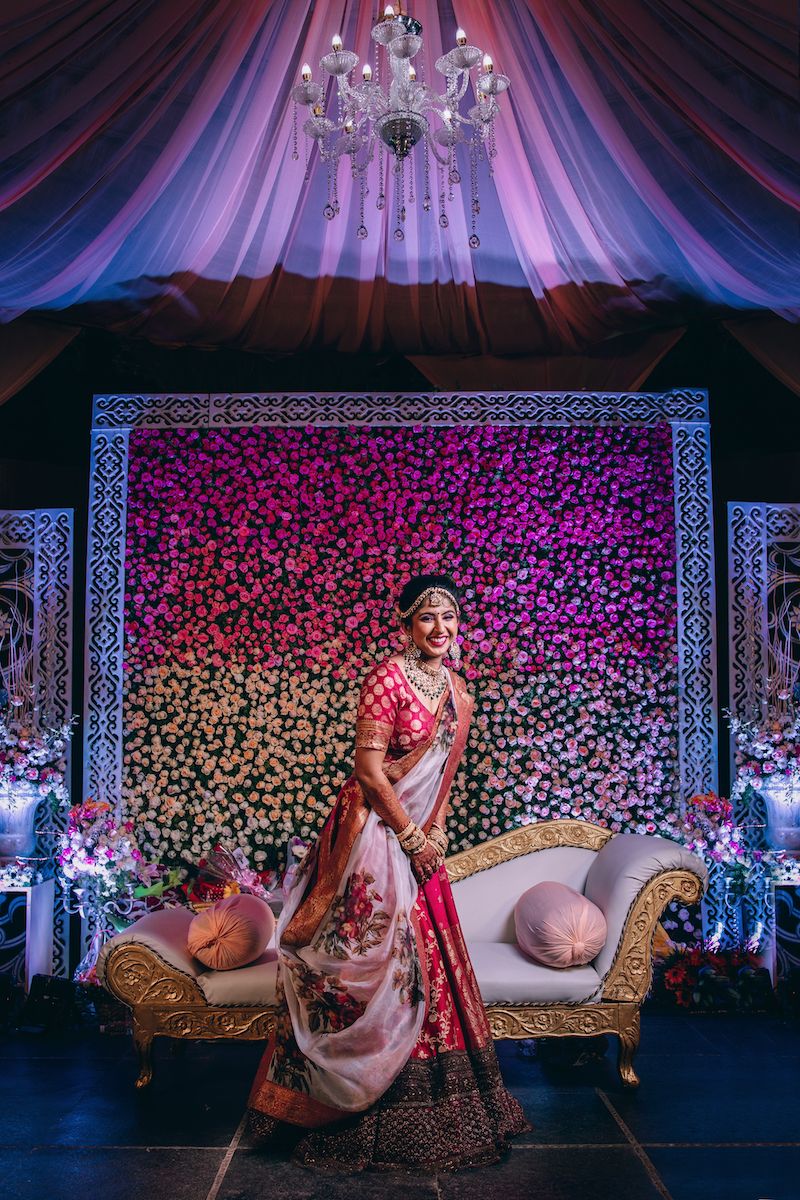 Photo of Happy bride in red and floral sabyasachi lehenga