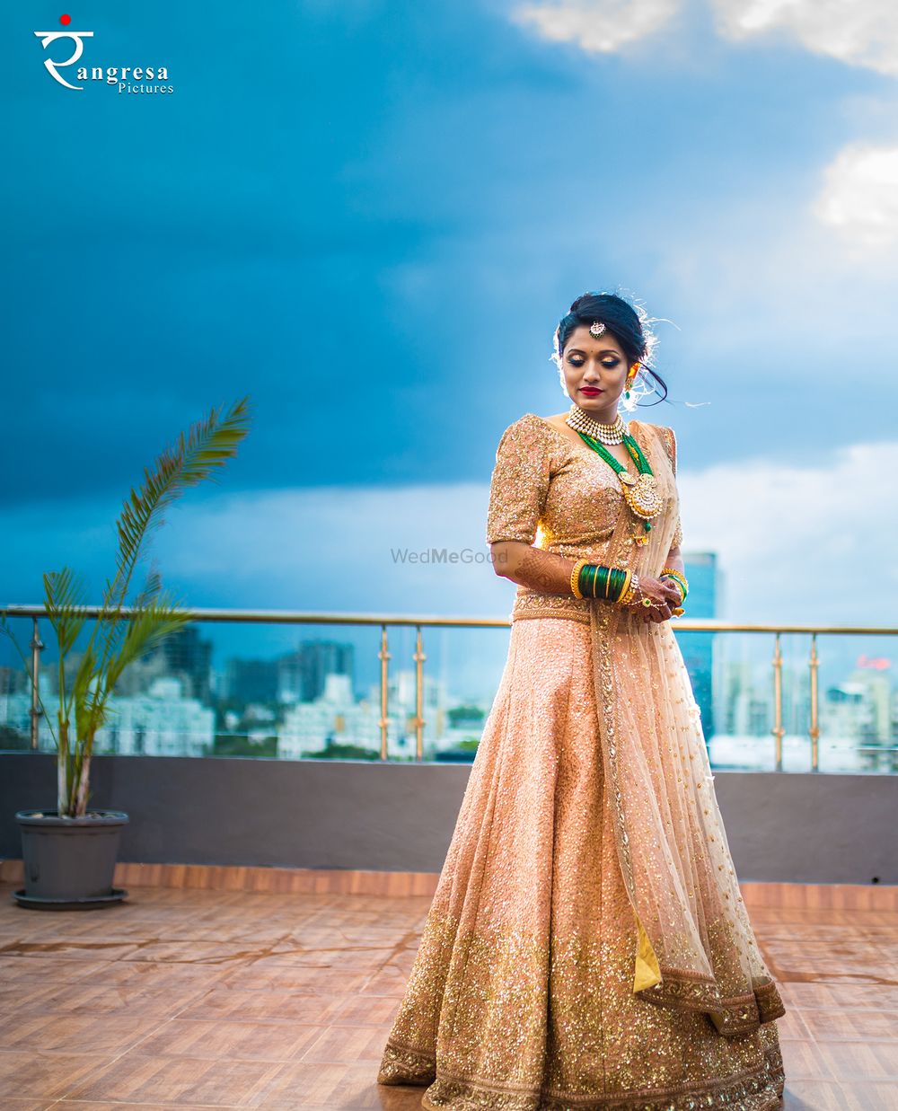 Photo of Shimmery gold lehenga with sequins and green jewellery