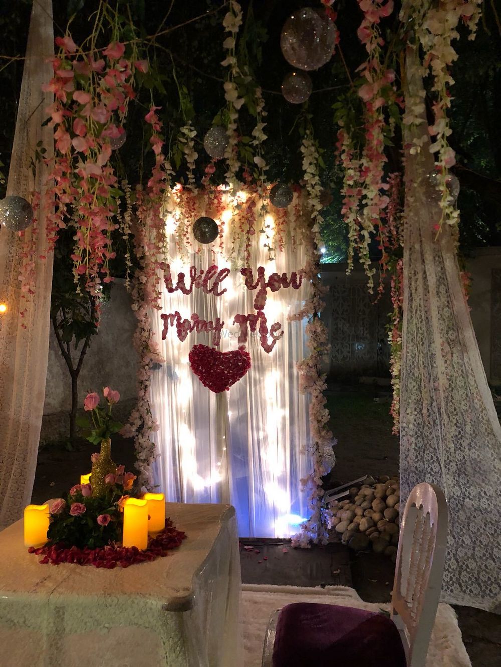Photo of Cute proposal idea with curtains and flowers