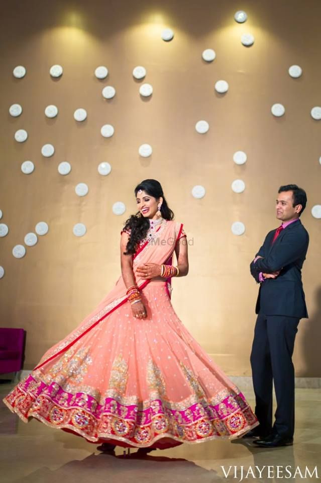 Photo of Pastel Peach and Hot Pink Twirling Lehenga