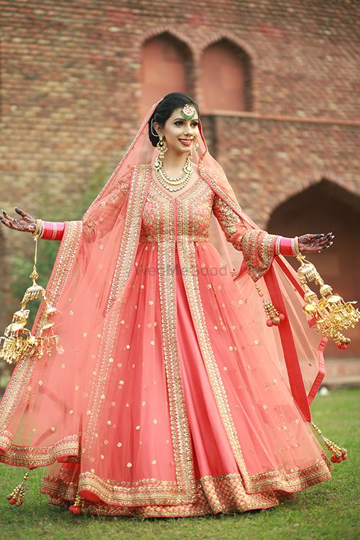 Photo of Sikh bride in gold and coral anarkali with kaleere