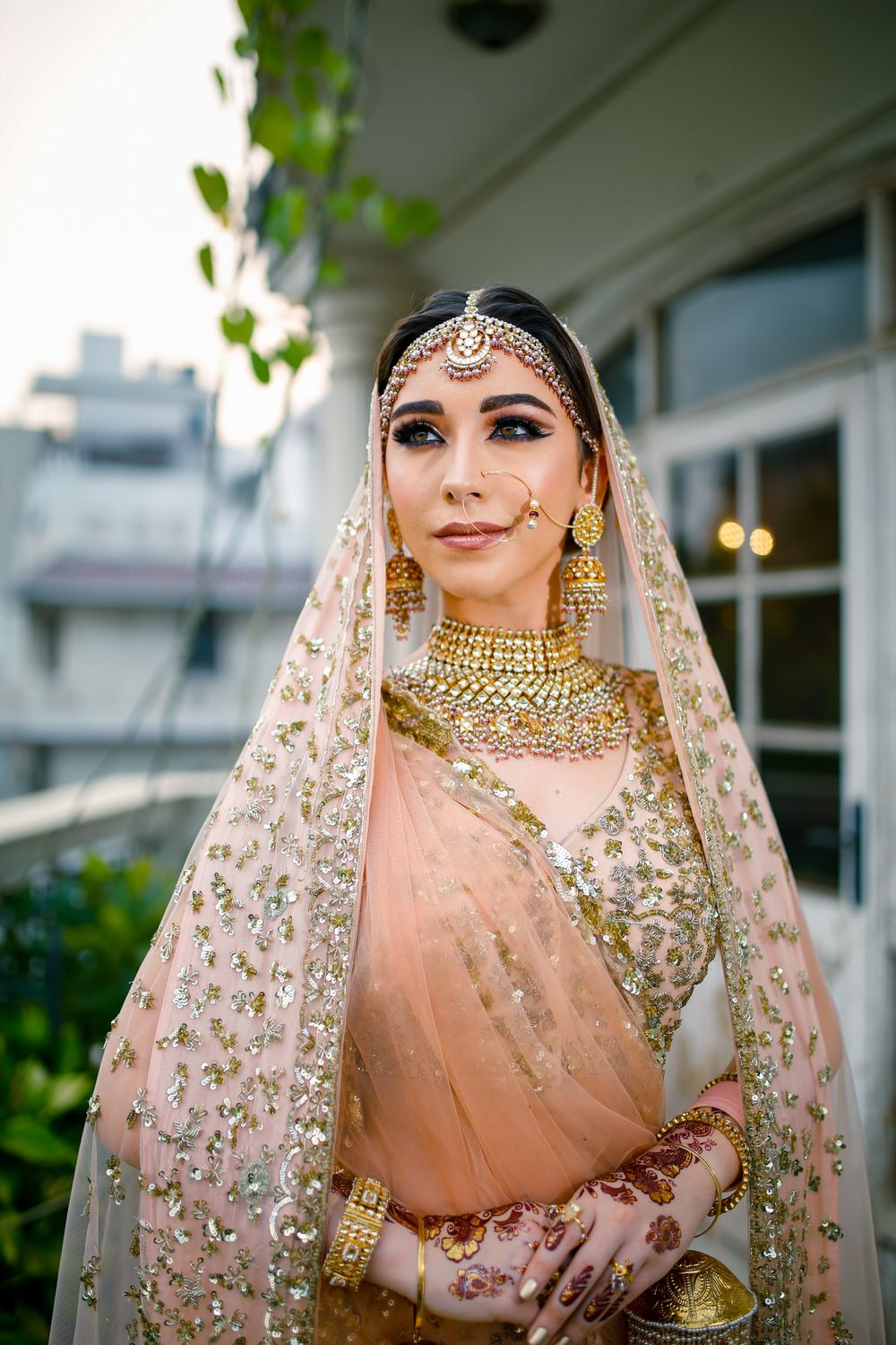 Photo of peach bridal lehenga with gold sequins
