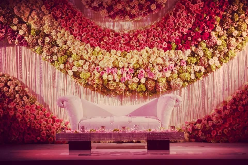 Photo of Stage decor idea for engagement with floral wall