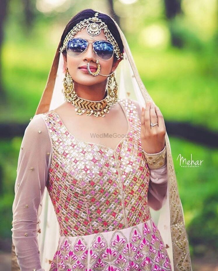 Photo of Pretty bride with sunglasses on her wedding day