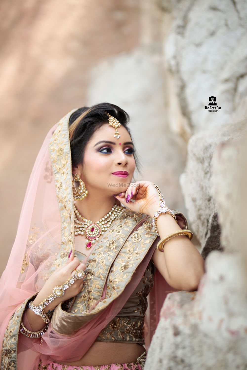 Photo of A bride in pink and gold lehenga