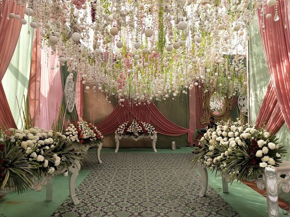 Photo of Grand entrance decor with cascading flowers and flowy drapes.
