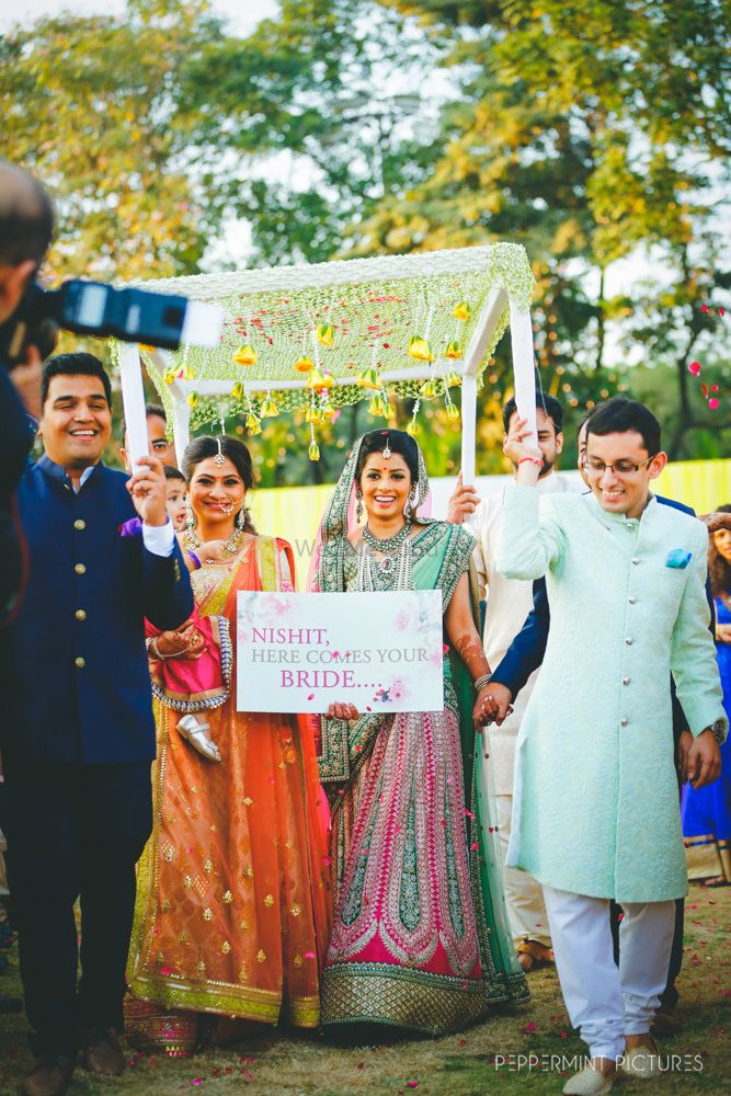 Photo of Bridal entry idea under phoolon ka chadar with sign