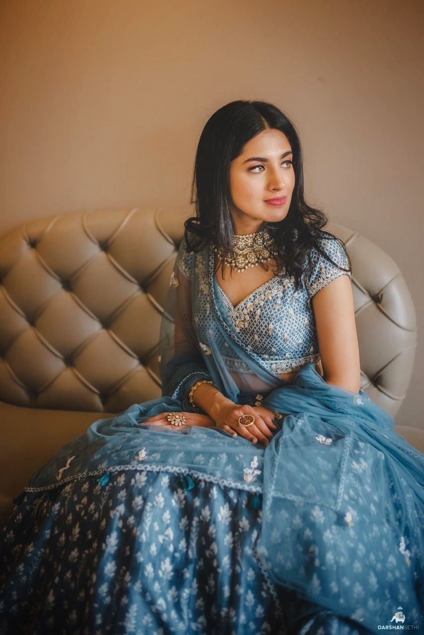 Photo of engagement lehenga in blue with light jewellery