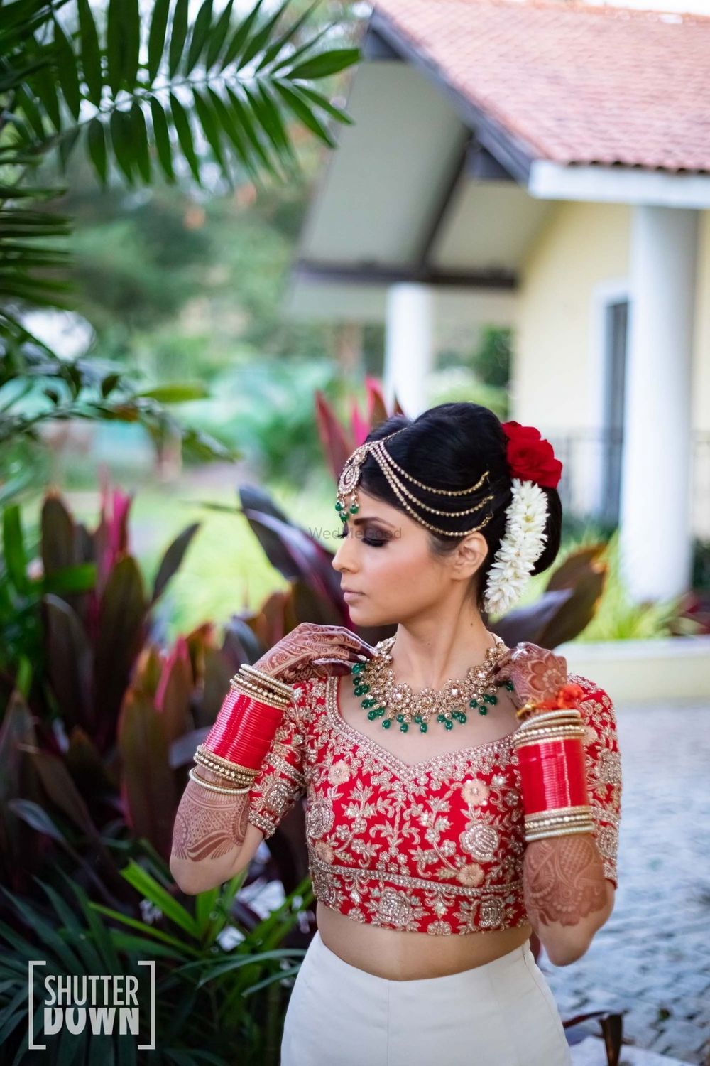 Photo of Bride getting ready shot in blouse and choora
