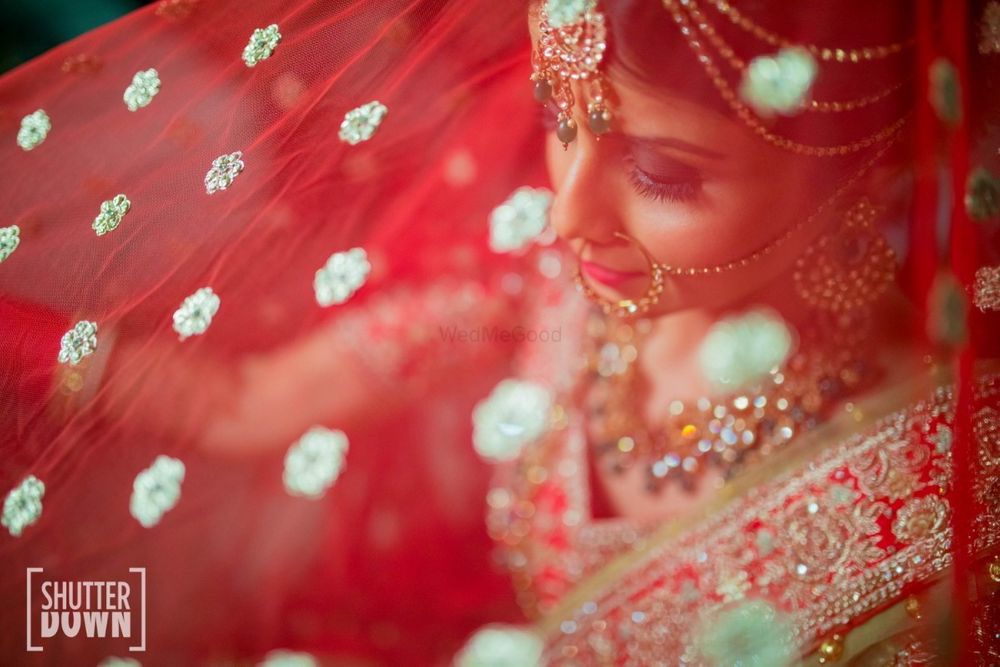 Photo of Bride getting ready shot using dupatta as veil