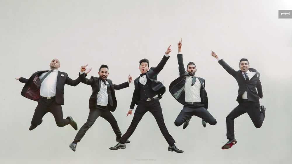 Photo of Groom jumping with groomsmen