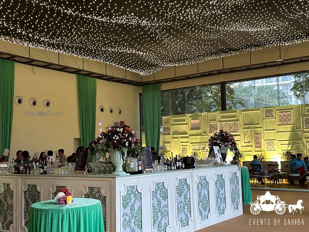 Photo of Fun bar set up with floral arrangement and a starry night lights set up